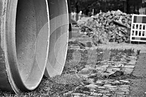 Pipes in sand near road photo