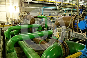 Pipes and sewage pumps inside modern industrial wastewater treatment plant