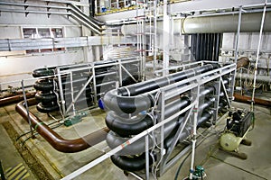 Pipes and sewage pumps inside modern industrial wastewater treatment plant