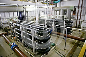 Pipes and sewage pumps inside modern industrial wastewater treatment plant