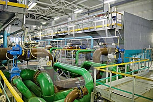 Pipes and sewage pumps inside modern industrial wastewater treatment plant