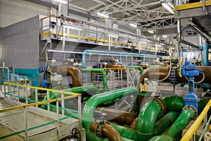 Pipes and sewage pumps inside modern industrial wastewater treatment plant