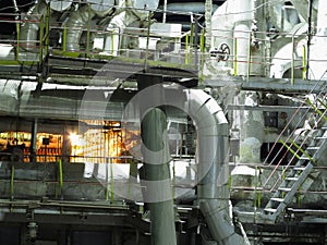 Pipes, steel tubes, steam turbine and equipment at power plant, night scene