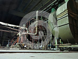 Pipes, steel tubes, steam turbine and equipment at power plant, night scene