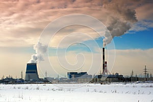 Pipes of thermal power station. Steam and smoke. Industrial factory landscape