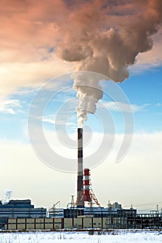 Pipes of thermal power station. Steam and smoke. Industrial factory landscape