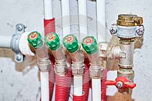 Pipes and valves for hot and cold water in a heating and water supply system