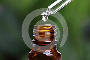 Pipette and bottle of essential oil photo
