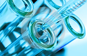 Pipette and test tube on blue background