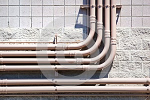 Piping Mounted on a Masonry Wall of a Building