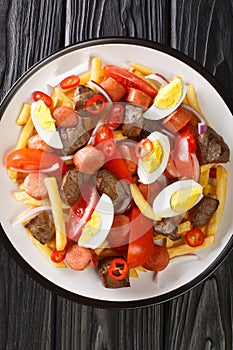 Pique macho is a very popular dish from Bolivia made of beef cuts and fried sausages with fries, eggs, chili peppers and tomatoes