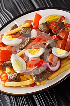 Pique macho is a very popular dish from Bolivia made of beef cuts and fried sausages with fries, eggs, chili peppers and tomatoes