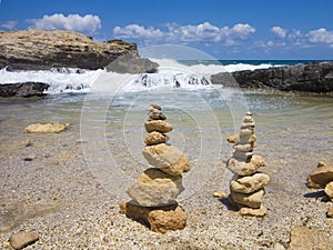 Piramide stack of zen stones near sea and blue sky