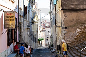 Piran, Slovenia; 7/19/19: Narrow alley with colorful slovenian houses in the old town of Piran, in Slovenia