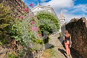 Piran - Tourist woman strolls the scenic streets coastal town Piran, Primorska, Slovenia, Europe