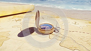 Pirate compass on the Treasure Map lying on the sand on the island of pirates. Vintage beautiful pirate compass lying on