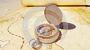 Pirate compass on the Treasure Map lying on the sand on the island of pirates. Vintage beautiful pirate compass lying on