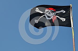Pirate flag against blue sky, copy space