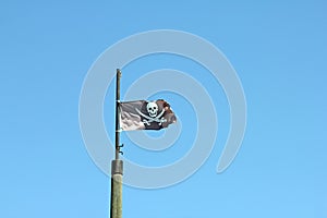 Pirate flag on blue background  stock photo