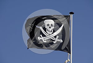 Pirate flag flying in blue sky