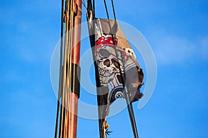 The pirate flag or the Jolly Roger - old shabby black flag with a skull