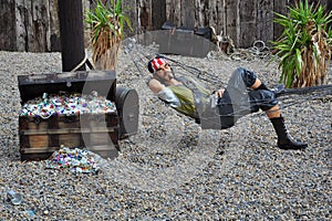 Pirate in hammock by treasure chest