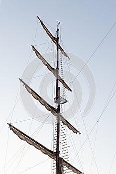 Pirate ship mast on blue sky background