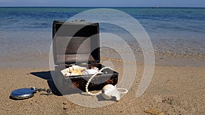 a pirate treasure chest on a sandy beach.a treasure trove of seashells, antique watches and jewelry found