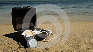 a pirate treasure chest on a sandy beach.a treasure trove of seashells, antique watches and jewelry found