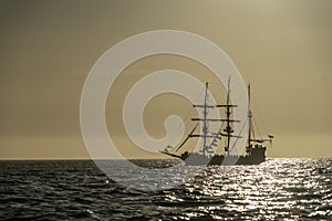 Pirate vessel silhouette at sunset