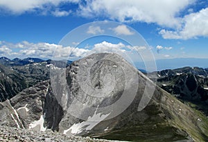 Pirin mountains in Bulgaria, gray rock summit during the sunny day with clear blue sky