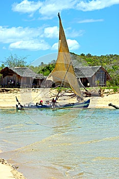 pirogue beach seaweed in indian ocean house people