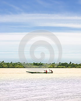 A pirogue navigates on the river niger