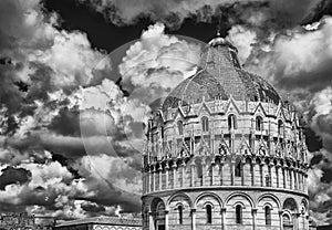 Pisa Baptistry dome with clouds and walls