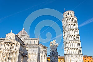 Pisa cathedral and the leaning tower and sculpture in a sunny day in Pisa, Italy