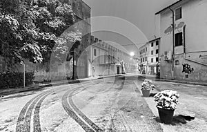 PISA, ITALY - MARCH 1, 2018: Street of Pisa with snow on a winter morning. Last snowfall had been in 2010
