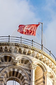 Pisa tower detail - showing the top roof area with the red flag 2