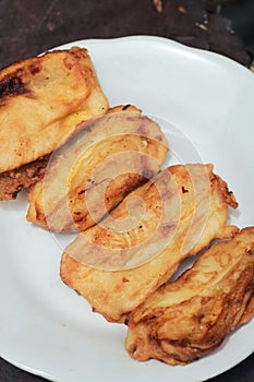 Pisang goreng or fried bananas on a white plate, Pisang goreng are fried foods that are often consumed by Indonesian people