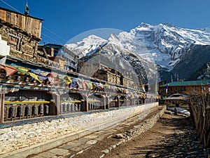 Pisang village prayer wheel alley with Annapurna mountain background