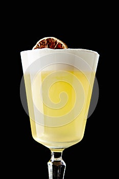 Pisco Sour with Freshly Squeezed Lime Juice, Simple Sweet Syrup, Ice, Egg White and Angostura Bitters on Black Background