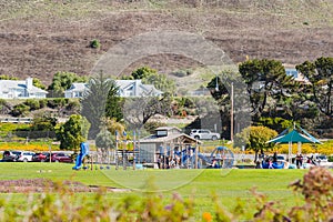Dinosaur Caves Park, playground and walking trail, grassy lawn, green hills, and Ocean view. Park is the city`s most used event
