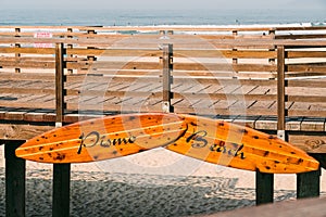 Pismo Beach sign on wooden boardwalk. Pismo Beach pier, California