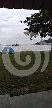 Piss time, beach, tent, greenplant, white sky photo