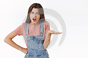 Pissed, angry complaining woman staring outraged, raise on hand in dismay or scorn, arguing, having fight with coworker