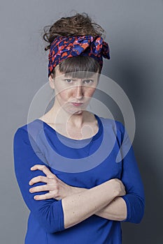 off young woman with trendy hairstyle sulking, looking furious