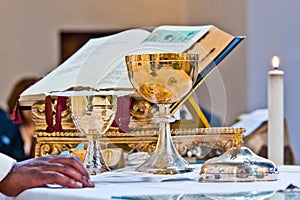 Pisside and chalice contain wine and hosts on the altar of the m