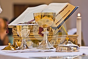 Pisside and chalice contain wine and hosts on the altar of the m