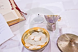 Pisside and chalice contain wine and hosts on the altar of the m photo