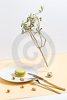 Pistachio cake makaroons and pistachios on a beige background. Top view