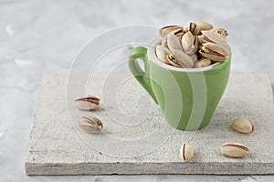 Pistachio in glass. Nuts. Green fresh pistachios as texture. Roasted salted pistachio nuts healthy delicious food studio photo. photo